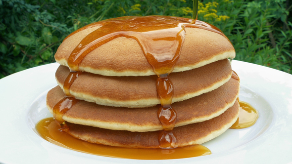 Syrup Pours Onto Pancakes Outside On Table