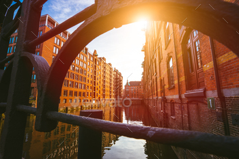 dings made with red bricks. Bridge and sun rays in low angle view.