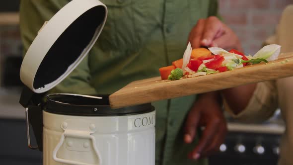 Senior African American husband and mixed race wife cooking together at home