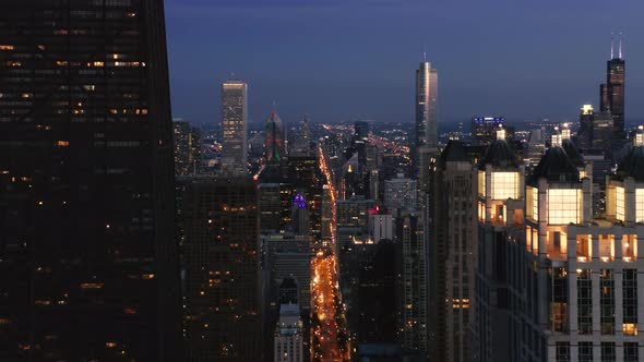 Descending Aerial Shot of Chicago Downtown Skyline in Night Illumination USA