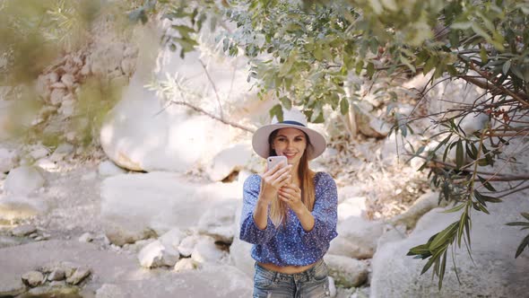 Woman in Summer Outfit Taking Selfie on Mobile During Trip