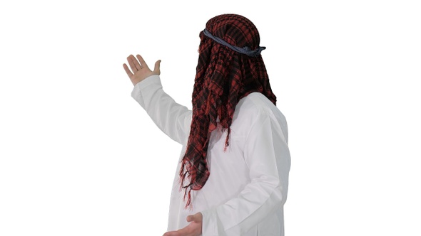Sheikh wearing keffiyeh doing welcome gesture on white background.