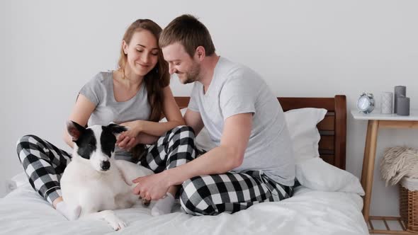 Couple with Dog in the Bed