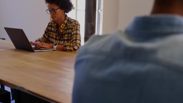 African American Businesswoman using laptop in a modern office 4k