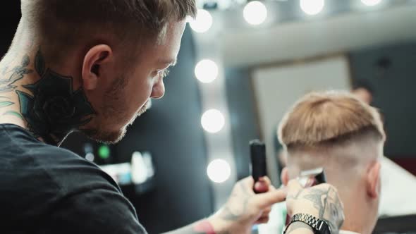 Hairdresser Makes Haircut To the Client