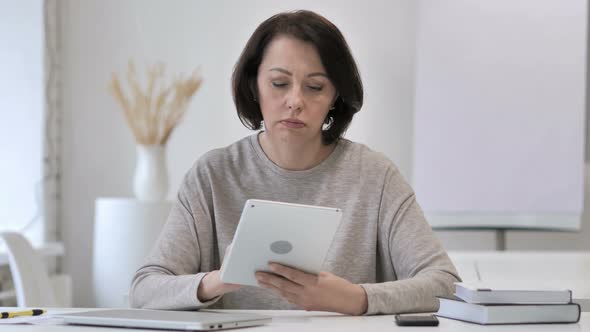 Old Senior Woman Browsing Internet on Tablet