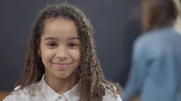 Portrait of Charming Confident Smart African American Schoolgirl with Toothy Smile Posing in