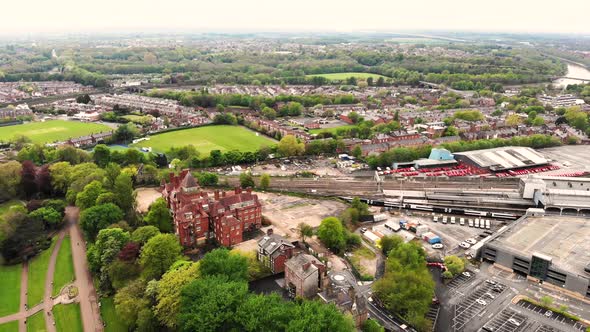 Reverse aerial shot of a train leaving Preston train station