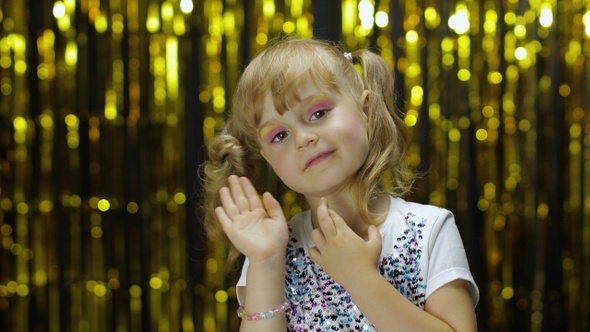 Shy Girl Is Ashamed. She Waves Her Hand. Little Fun Blonde Kid Teen Teenager Girl 4-5 Years Old