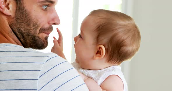 Father kissing his baby girl on forehead