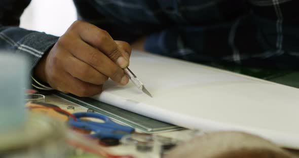 Man making a design on skateboard 4k