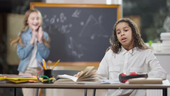 Stressed African American Schoolgirl Sighing Having Problems As Caucasian Smart Classmate Helping