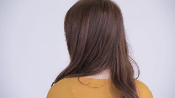 Closeup Rear View of Young Happy Asian Woman Smiling and Looking Back