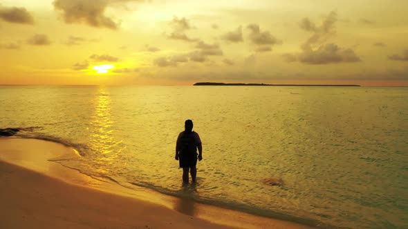 Woman relaxing on exotic tourist beach break by blue lagoon and white sandy background of the Maldiv