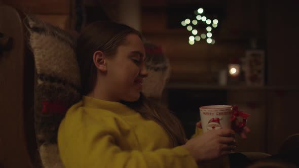 A woman holding a Christmas mug