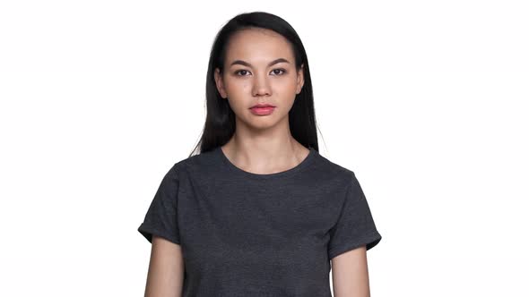 Portrait of Gorgeous Asian Woman with Long Dark Hair in Basic Tshirt Looking at Camera with