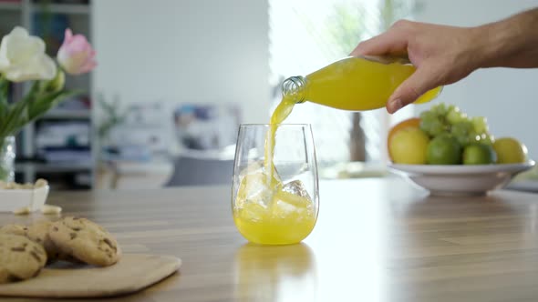 Filling Glass With Yellow Soda Drink