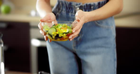 Woman Brings a Bowl of Salad to Her Face to Feel the Aroma