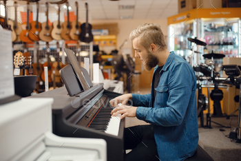 re. Assortment in musical instruments shop, keyboardist buying equipment, pianist in market