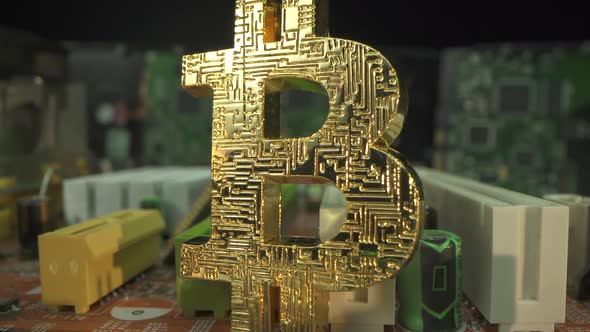 Gold Symbol of Crypto Traiding Bitcoin BTC on the Motherboard in Super Macro Shot