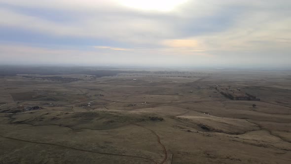 Flying from very high down above a grassy area of ​​the Central Valley foothills of the Sierra Nevad