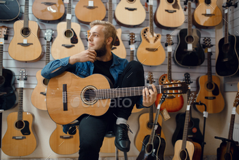  Assortment in musical instruments shop, male musician buying equipment
