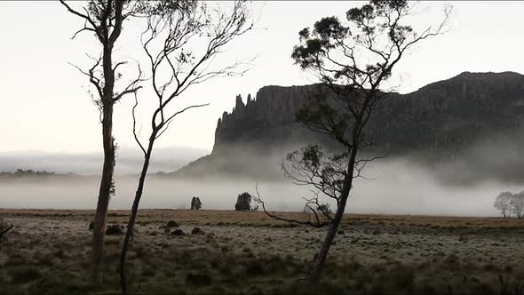 Timelapse of Mist Shot Early in the Morning Against a Mountain Backdrop