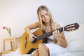 Girl Playing Guitar at Home - PhotoDune Item for Sale