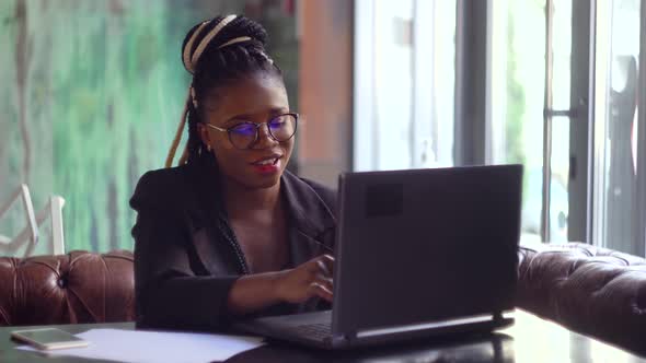 Smiling Young Black Woman Receptionist Video Conference Calling on Laptop Computer Talk By Webcam 