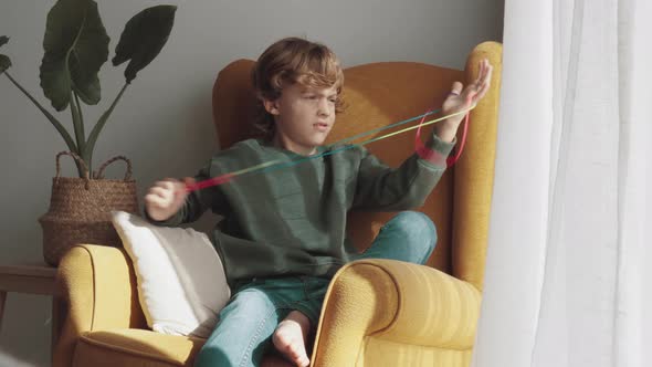 Happy boy enjoying string game at home