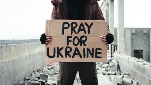 Ukrainian Boy Holding an Antiwar Placard in His Hand