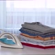 Iron And A Stack Of Clean Clothes On An Ironing Board - VideoHive Item for Sale