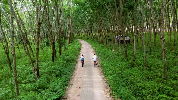 Couple Men and Woman on Bicycle in the Jungle of Koh Yao Yai Thailand Men and Woman Bicycling