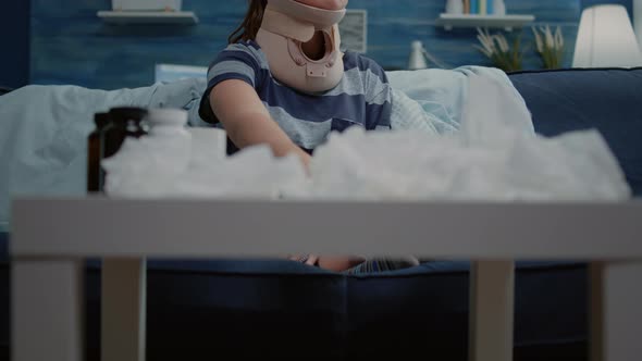 Close Up of Person with Cervical Neck Collar Looking at Capsule Tablets