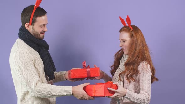 Attractive Young Couple Is Ready To Exchange Christmas Gifts