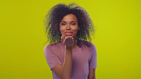 African Woman Blows Air Kiss To Beloved Boyfriend Over Yellow Background