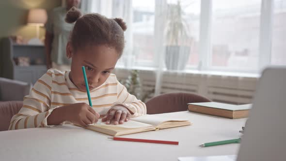 Little Girl Drawing at Home