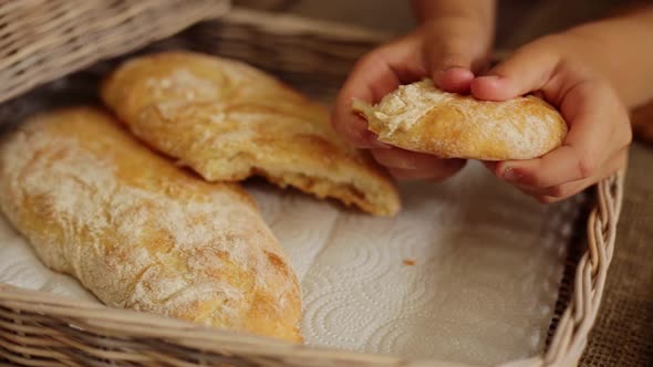 Girl Breaking Freshly Baked Ciabatta at Home