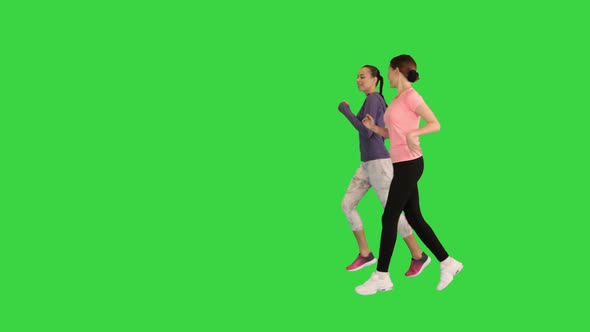 Group of Two Runner Women Running on a Green Screen Chroma Key