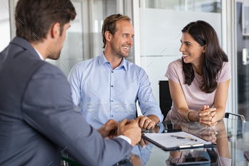 r investment at modern office. Financial consultant presents bank investments to confident man and happy woman. Middle aged couple consulting their bank agent about savings plan.