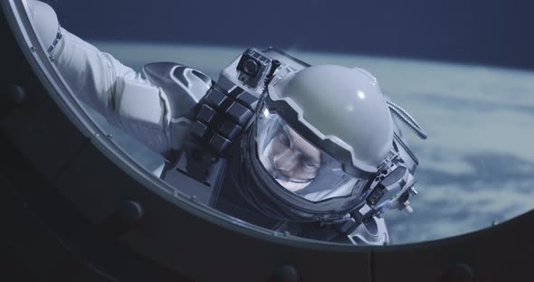Astronaut Floating By Spacecrafts Window