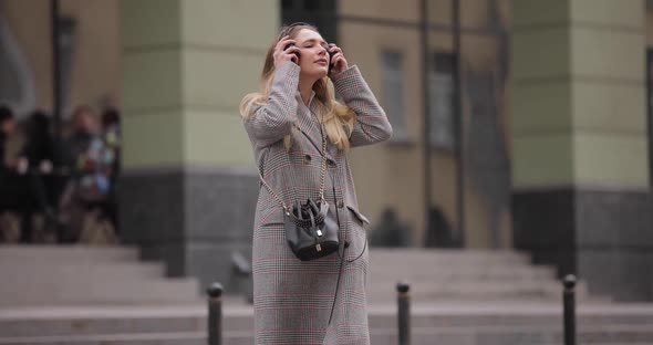 Slow Motion Woman Wearing Headphones Walking in the City