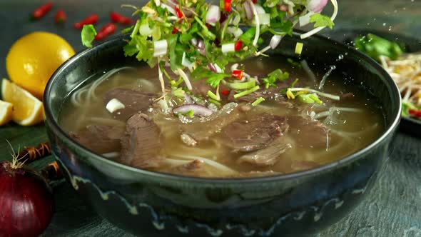 Super Slow Motion Shot of Ingredients Falling Into Beef Pho Soup at 1000 Fps