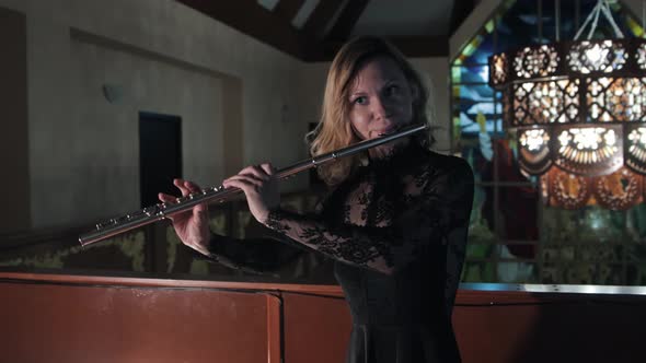Female Flutist Playing Music in Christian Church