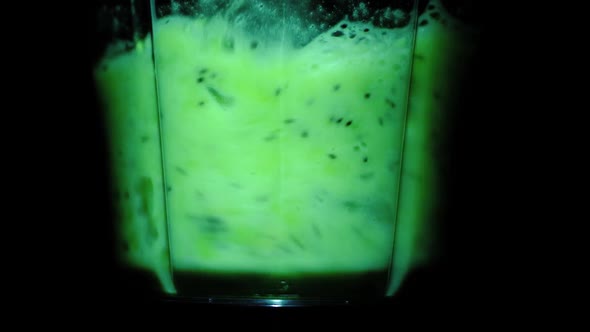Kiwi Fruit Mixed in a Blender on a Black Background