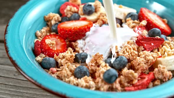 Pouring Milk on Cereals at Bowl in Super Slowmotion.