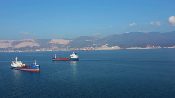 Aerial View of Two Large Cargo Ships Leaving Sea Harbour at Sunny Day