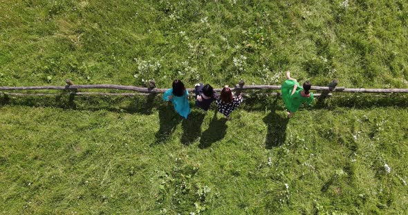 Young Girls Rest And Rejoice In The Meadow 