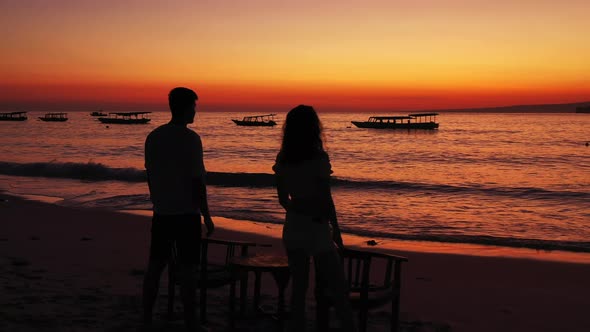 Beautiful Lady and Man on Romantic Honeymoon Enjoy Luxury on Beach on Paradise White Sand Background