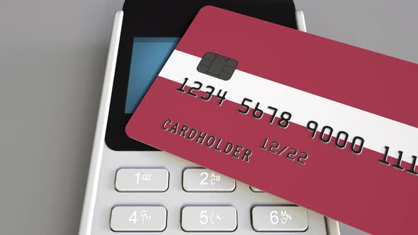 Bank Card with Flag of Latvia and POS Terminal alt